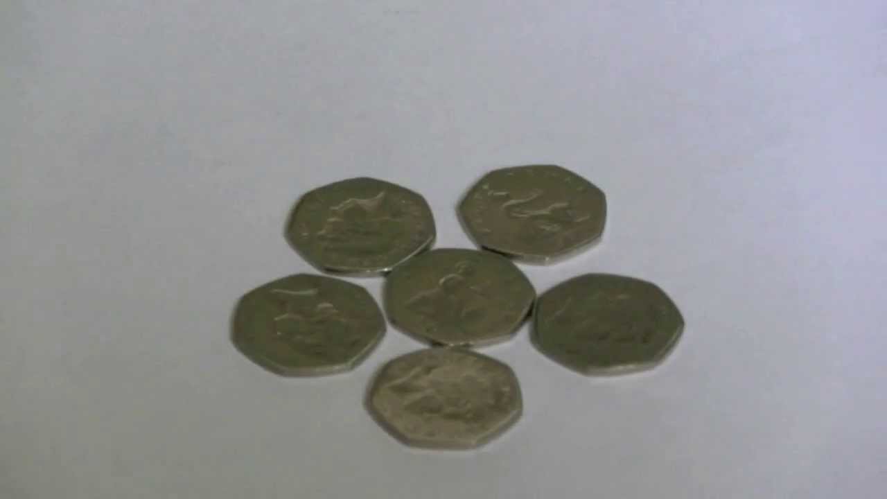 Coins in savings jar stop motion on whit | Stock Video | Pond5